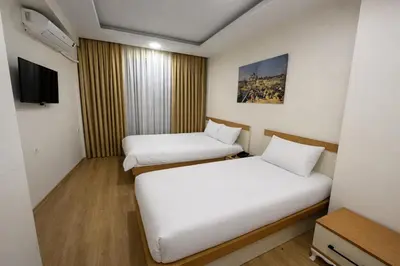 a hotel room with two beds and a tv at VALENCE SUITES Taksim in Istanbul