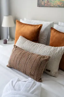 a pile of pillows sitting on top of a bed at Iconic Sea View Duplex w Terrace in Balat in Istanbul