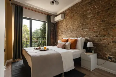 a bedroom with a brick wall and a large bed at Iconic Sea View Duplex w Terrace in Balat in Istanbul