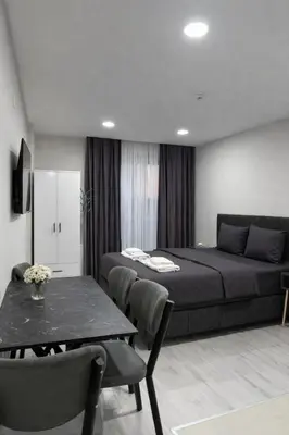 a bedroom with a bed and a table and chairs at Signature Suites in Taksim in Istanbul