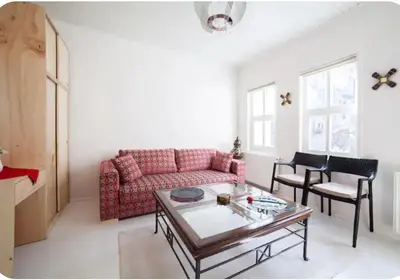a living room with a red couch and a table at Two seperate apartments for friends and families in Istanbul