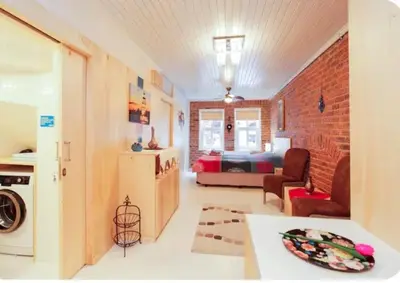 a kitchen and living room with a brick wall at Two seperate apartments for friends and families in Istanbul