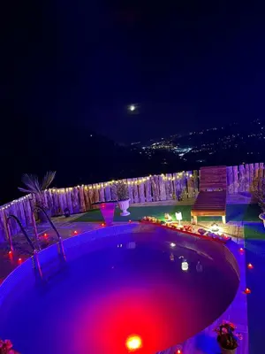 a swimming pool at night with red and purple lights at Sakaryabungalow in Geyve