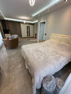 a large bedroom with a large bed and a chair at Villa life in Gümüşyaka