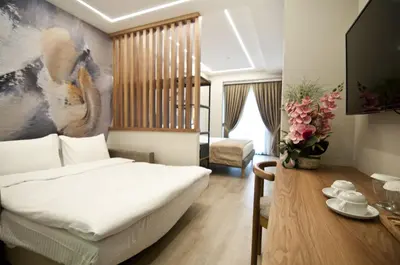 a bedroom with a bed and a table with flowers at Forty Nişantaşı Hotel & SPA in Istanbul