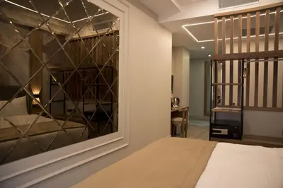 a bedroom with a large mirror and a bed at Forty Nişantaşı Hotel & SPA in Istanbul