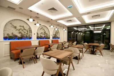 a restaurant with tables and chairs and windows at Forty Nişantaşı Hotel & SPA in Istanbul