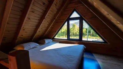a large bed in a room with a large window at Regulus Sapanca in Sapanca