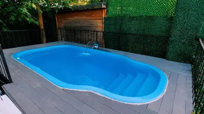 a blue hot tub on a deck with a fence at Regulus Sapanca in Sapanca
