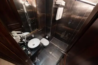 a small bathroom with a sink and a toilet at Atik Hotel Nişantaşı in Istanbul