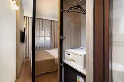 a small room with a bed and a door to a bedroom at Atik Hotel Nişantaşı in Istanbul