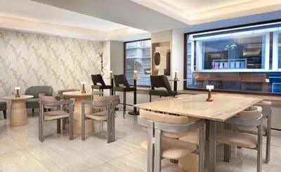 a restaurant with tables and chairs and a large window at Atik Hotel Nişantaşı in Istanbul