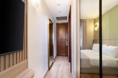 a hotel room with a bed and a mirror at Atik Hotel Nişantaşı in Istanbul