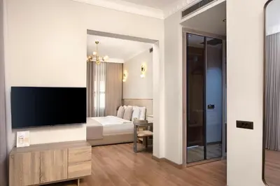 a living room with a large flat screen tv at Atik Hotel Nişantaşı in Istanbul