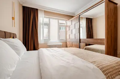 a bedroom with a large white bed and a piano at Samuray in Istanbul