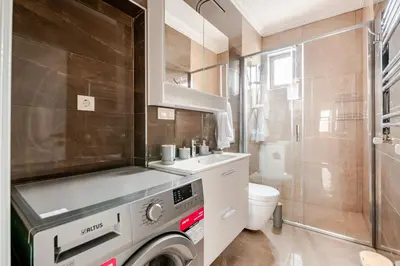 a small bathroom with a washing machine in it at Samuray in Istanbul