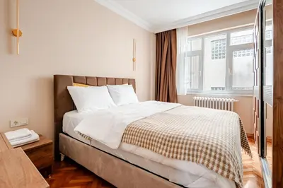 a bedroom with a large bed and a window at Samuray in Istanbul