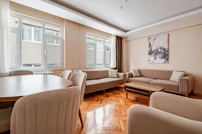 a living room with couches and a table and chairs at Samuray in Istanbul