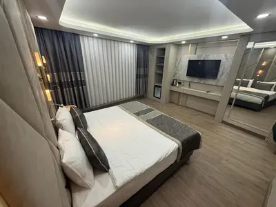 a bedroom with a large bed and a living room at Elysia Plus in Istanbul
