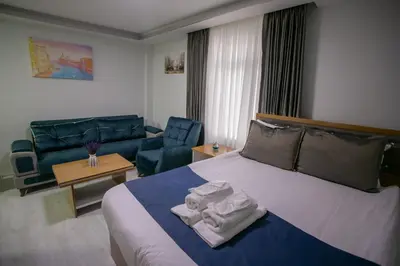 a hotel room with a bed and a couch at Güven House İstanbul in Istanbul
