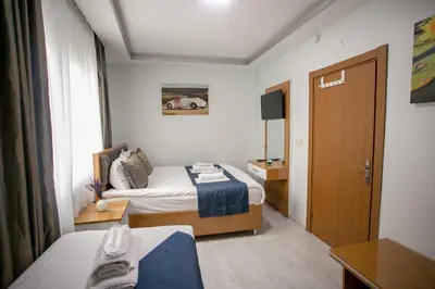 a hotel room with a bed and a window at Güven House İstanbul in Istanbul