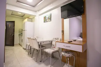 a kitchen with a table and chairs in a room at Güven House İstanbul in Istanbul
