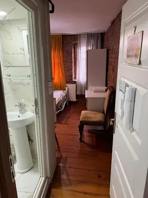 a bathroom with a sink and a bedroom at suite near Taksim square in Istanbul