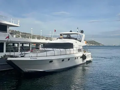 a white boat is docked in the water at Rotavira YAT KİRALAMA PLATFORMU in Istanbul