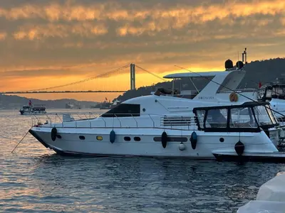 a white boat in the water with a bridge in the background at Rotavira YAT KİRALAMA PLATFORMU in Istanbul