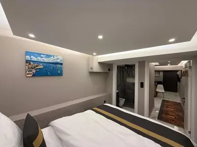 a bedroom with a bed and a painting on the wall at Cozy 1BR Basement Apartment Close to Metro in Istanbul
