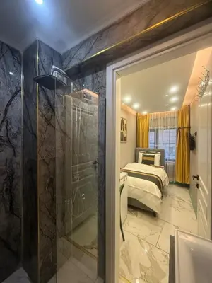 a bathroom with a shower and a bed in a room at Cozy Studio Near Taksim Metro Station in Istanbul