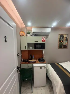 a small room with a bed and a small kitchen at Cozy Studio Near Taksim Metro Station in Istanbul
