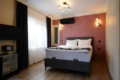 a bedroom with a bed and a tv on the wall at the apart galata in Istanbul