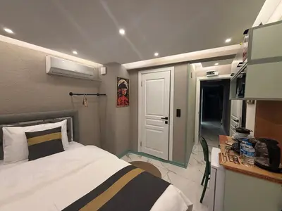 a small bedroom with a bed and a window at Modern Compact Studio Near Metro Station in Istanbul
