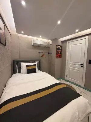 a bedroom with a bed with a black and yellow stripes at Modern Compact Studio Near Metro Station in Istanbul