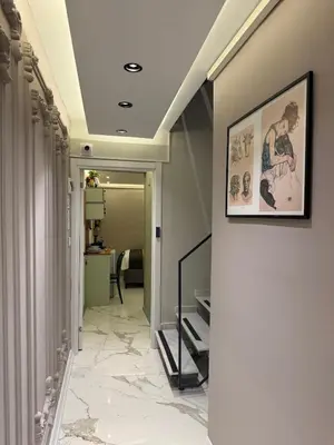 a hallway with marble floors and a picture on the wall at Modern Compact Studio Near Metro Station in Istanbul