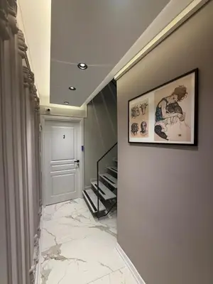 a hallway with a staircase and a picture on the wall at Warm cozy studio 8 min by metro station in Istanbul