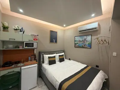 a small bedroom with a bed and a microwave at cozy studio apt near to taksim square in Istanbul