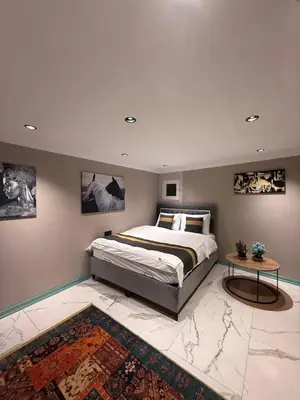 a bedroom with a large bed and a table at Cozy duplex with a private terrace near the metro in Istanbul