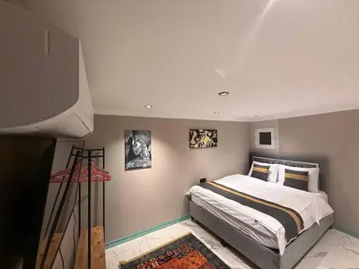 a bedroom with a bed and a television in it at Cozy duplex with a private terrace near the metro in Istanbul