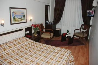 a hotel room with a bed and chairs at Hotel Grand Mark in Istanbul