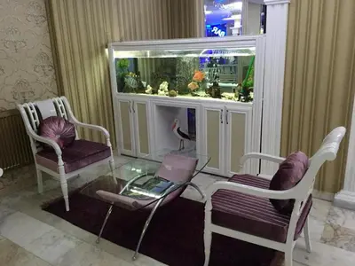 a living room with a glass table and a fish tank at Hotel Grand Mark in Istanbul