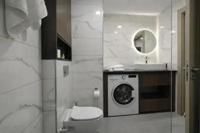 a bathroom with a washing machine and a sink at Hilloria Residence Hotel in Serdivan
