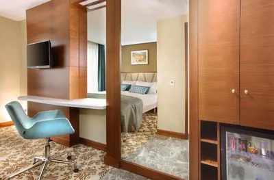 a room with a bed and a desk and a mirror at Mard-inn Hotel in Istanbul
