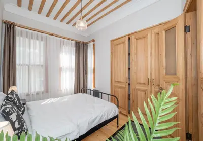 a bedroom with a bed and a wooden cabinet at acme studio in Istanbul