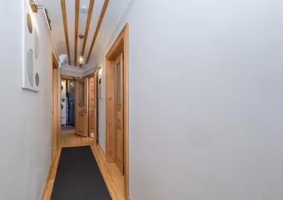 a hallway with a white wall and wooden ceilings at acme studio in Istanbul