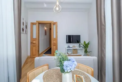 a dining room with a table with a vase of flowers on it at acme studio in Istanbul
