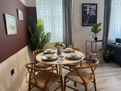 a dining room with a table and four chairs at Stylish Apartment 3 Min to Metro in Istanbul