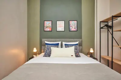 a bedroom with a bed with blue and white pillows at 2BR Modern Flat in Nişantaşı 3 Min to Metro Full AC in Istanbul