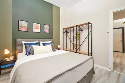 a bedroom with a large bed with blue and white pillows at 2BR Modern Flat in Nişantaşı 3 Min to Metro Full AC in Istanbul